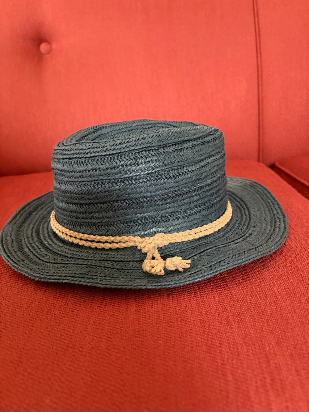 Athleta dark navy woven straw hat with tan braided band.